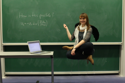 How is Joana managing to float in mid air? The equation on the board explains how the trick is done.